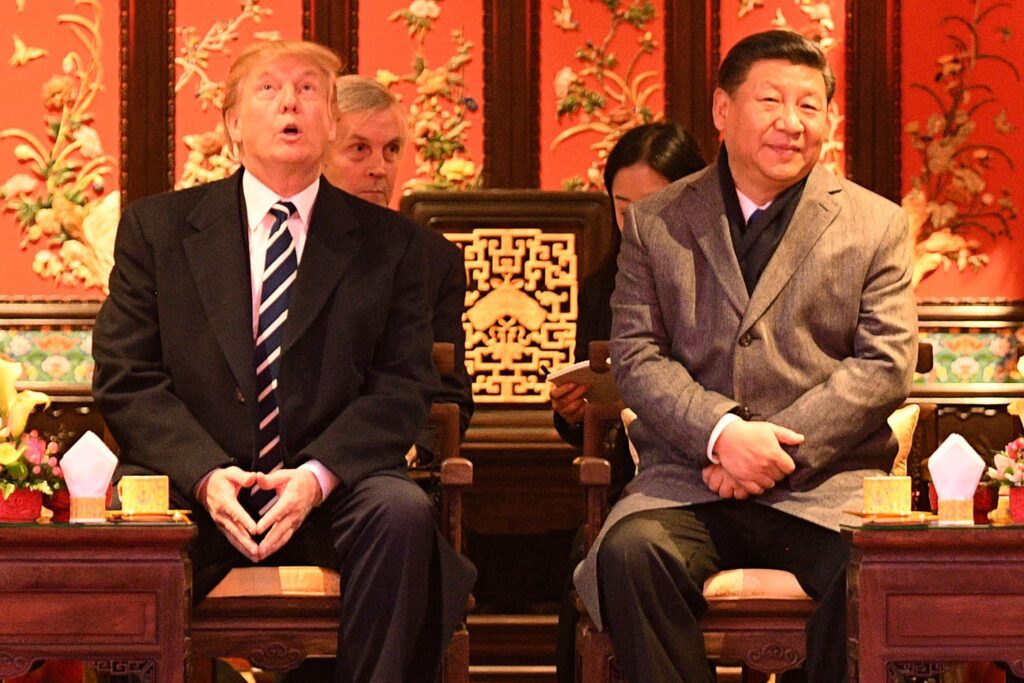 US President Donald Trump looks up as he sits beside China's President Xi Jinping in Beijing on November 8, 2017. AFP Contributor/AFP/Getty Images