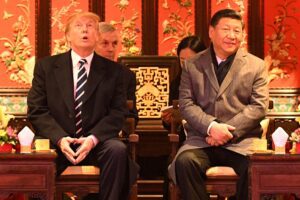 US President Donald Trump looks up as he sits beside China's President Xi Jinping in Beijing on November 8, 2017. AFP Contributor/AFP/Getty Images